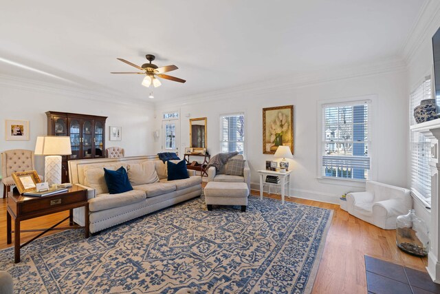 living room featuring crown molding, hardwood / wood-style flooring, a wealth of natural light, and ceiling fan