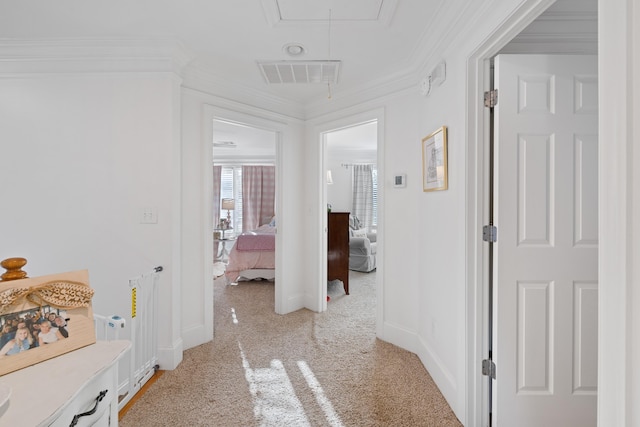 hallway featuring crown molding and light colored carpet