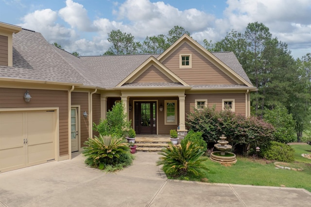 1020 Fairway Ridge Cir, Greensboro, GA 30642 - craftsman-style house featuring a shingled roof, driveway, a garage, and a porch