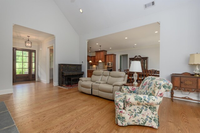1020 Fairway Ridge Cir, Greensboro, GA 30642 - living area with light wood-style floors, ornamental molding, recessed lighting, lofted ceiling, and baseboards