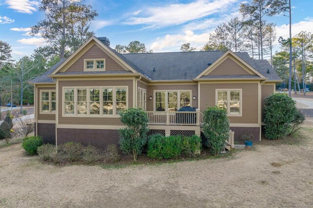 rear view of house with a wooden deck