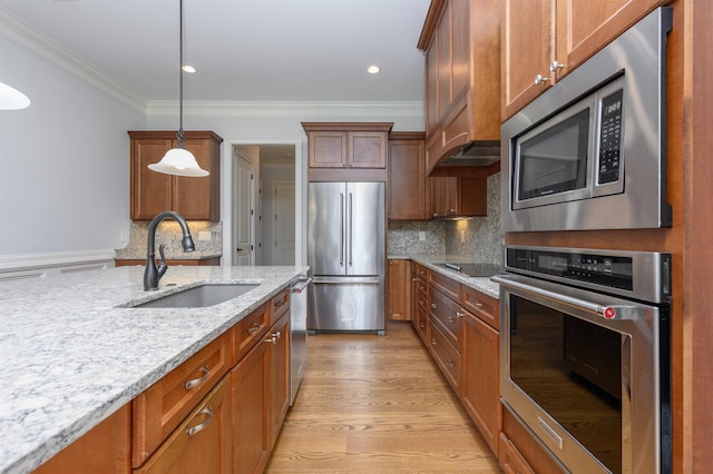 1020 Fairway Ridge Cir, Greensboro, GA 30642 - kitchen with stainless steel appliances, a sink, custom exhaust hood, crown molding, and brown cabinetry