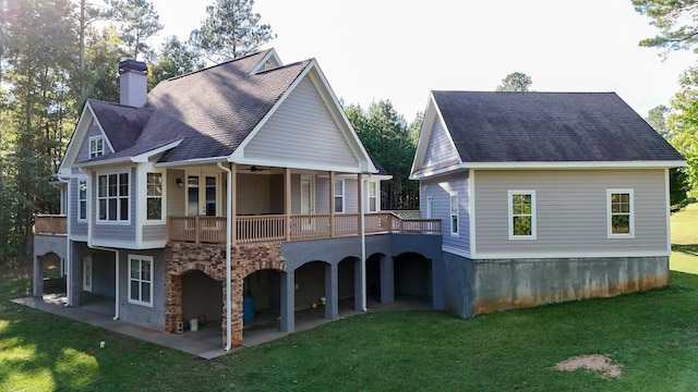 rear view of house featuring a yard, a patio, a balcony, and a deck