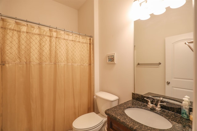 bathroom featuring vanity, toilet, and curtained shower