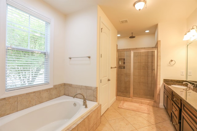 bathroom featuring tile patterned floors, vanity, and plus walk in shower