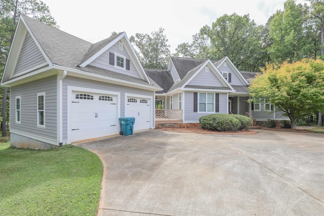 craftsman inspired home with a garage and a front yard