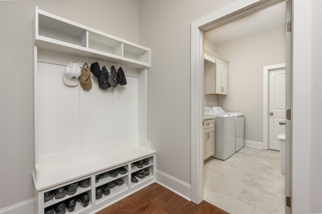 mudroom with hardwood / wood-style flooring and washing machine and dryer