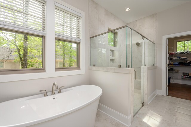 bathroom with separate shower and tub