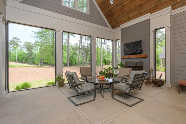 sunroom featuring vaulted ceiling, a wealth of natural light, and wood ceiling