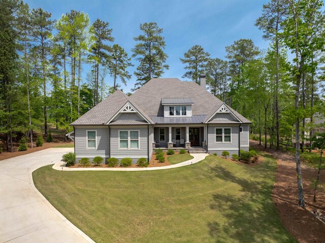 craftsman-style house with covered porch and a front yard