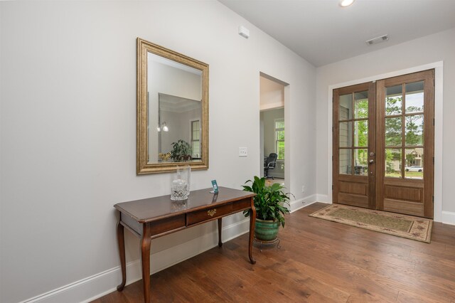 entrance foyer with french doors, plenty of natural light, and dark hardwood / wood-style floors