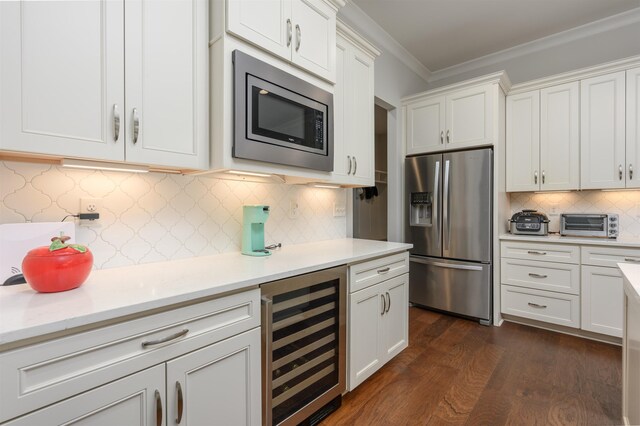 kitchen featuring white cabinets, appliances with stainless steel finishes, and wine cooler