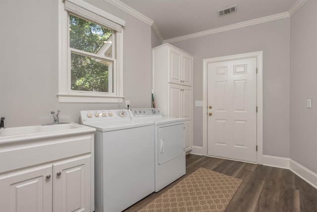 1051 Liberty Bluff Rd, Greensboro, GA 30642 - laundry area featuring cabinet space, separate washer and dryer, dark wood-style flooring, crown molding, and baseboards