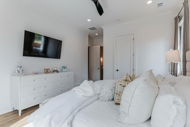 bedroom with crown molding, ceiling fan, and light wood-type flooring