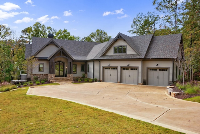 craftsman inspired home featuring a garage and a front yard