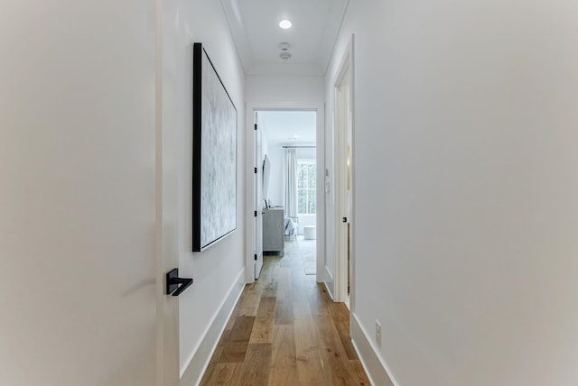 hallway with light hardwood / wood-style floors