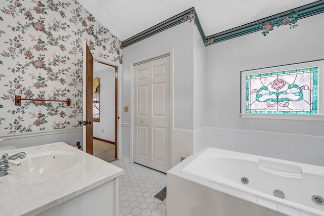 bathroom featuring vanity, tiled tub, and tile patterned floors