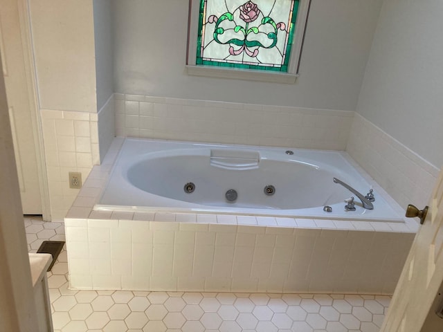 bathroom featuring vanity and a relaxing tiled tub