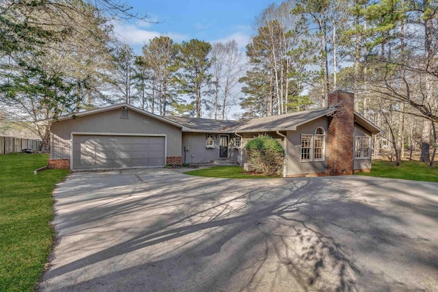 ranch-style home featuring a garage and a front lawn