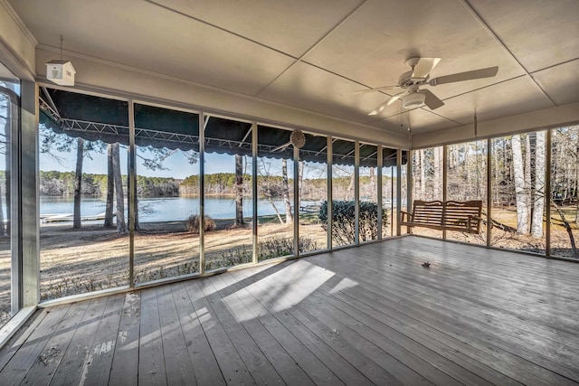 unfurnished sunroom featuring a water view and ceiling fan