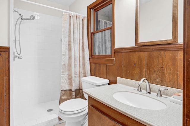 bathroom with vanity, a shower with curtain, wooden walls, and toilet