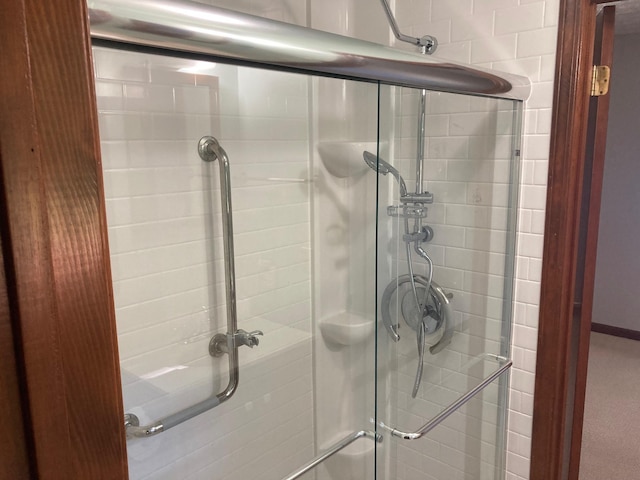 bathroom with a shower with door