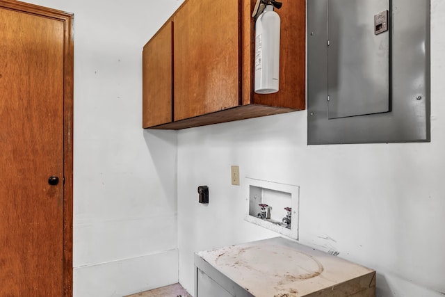 laundry room with cabinets, electric panel, and hookup for a washing machine