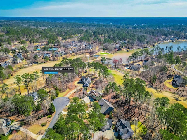 aerial view featuring a forest view and a water view