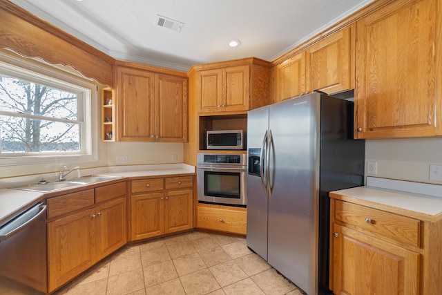 kitchen featuring light countertops, visible vents, appliances with stainless steel finishes, and a sink