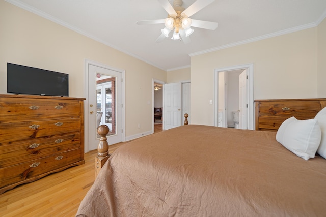 bedroom featuring crown molding, baseboards, light wood-style floors, ensuite bath, and a ceiling fan