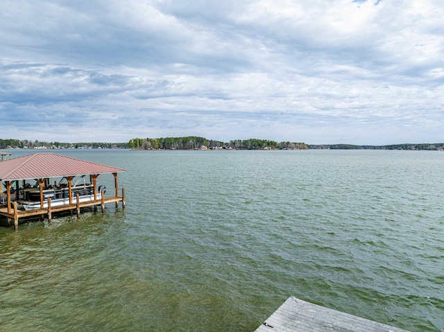 dock area with a water view and boat lift