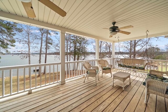 wooden terrace with ceiling fan and a water view