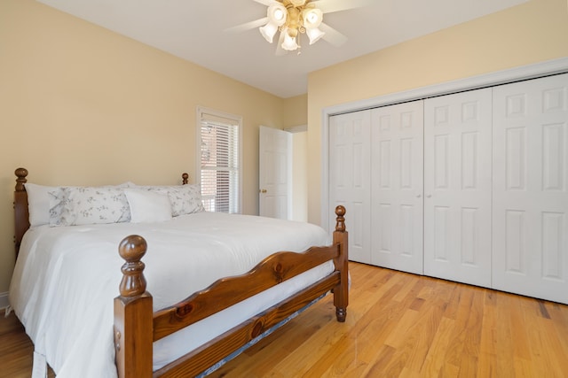 bedroom with ceiling fan, a closet, and light wood-style flooring