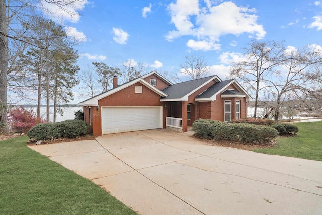 view of front of house with a front lawn, driveway, a garage, brick siding, and a chimney