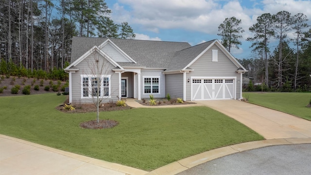 craftsman-style house featuring a garage and a front yard