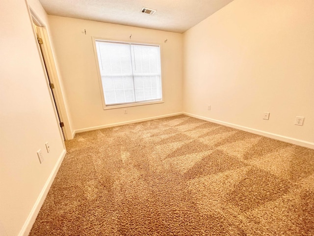 carpeted spare room featuring a textured ceiling