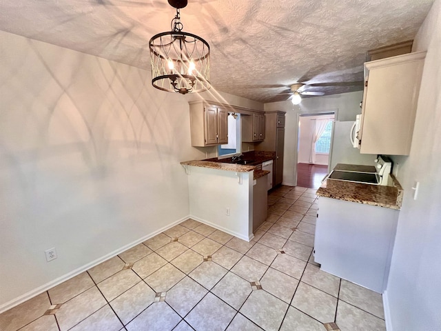 kitchen with range, a textured ceiling, kitchen peninsula, pendant lighting, and ceiling fan with notable chandelier