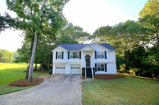 split foyer home with a garage and a front yard