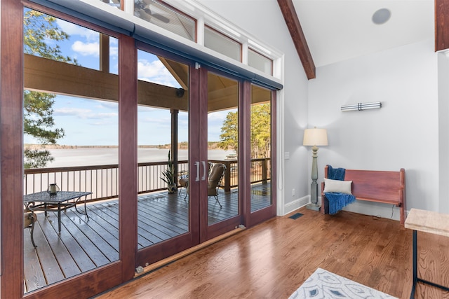 entryway featuring baseboards, beam ceiling, french doors, wood finished floors, and high vaulted ceiling