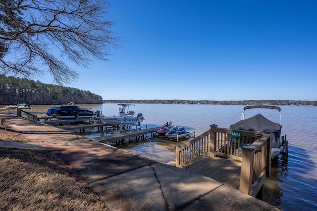 dock area with a water view and boat lift