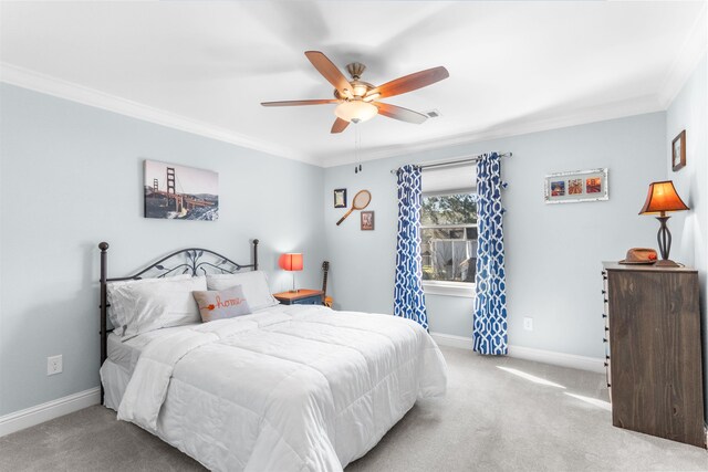 carpeted bedroom with baseboards, a ceiling fan, and crown molding