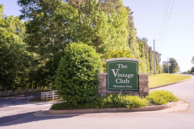 community sign featuring fence