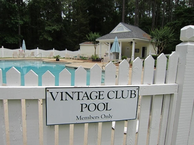 exterior space featuring a swimming pool and fence