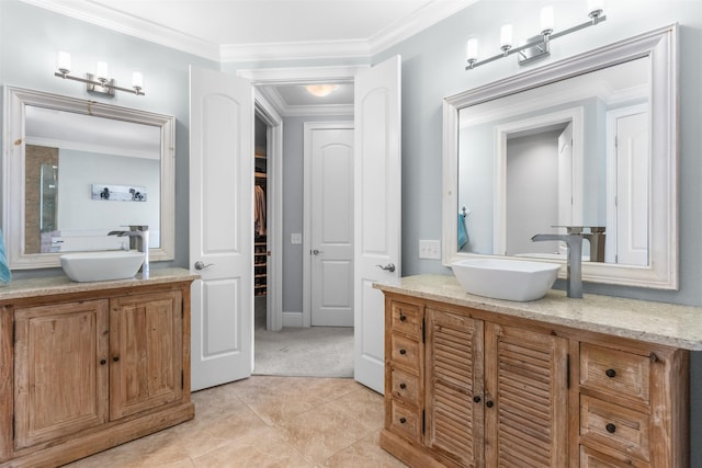 bathroom featuring a sink, two vanities, and ornamental molding