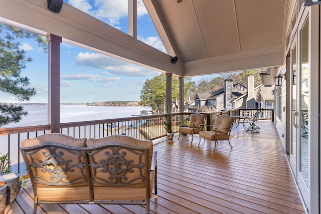 wooden terrace featuring a water view