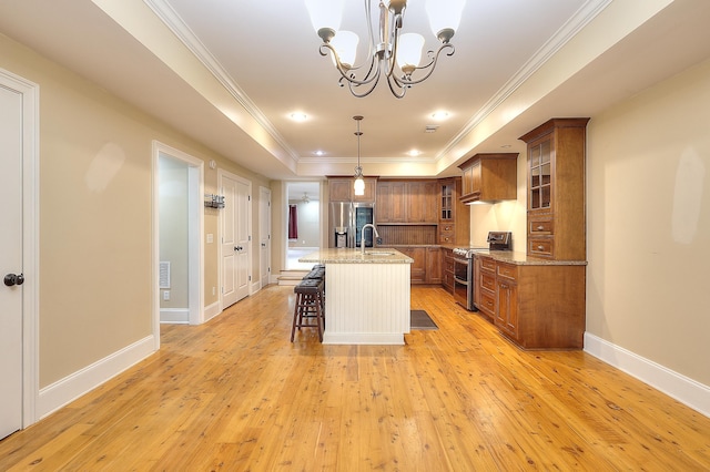 243 Riverbend Dr, Eatonton, GA 31024 - kitchen featuring appliances with stainless steel finishes, brown cabinetry, a chandelier, light stone counters, and crown molding