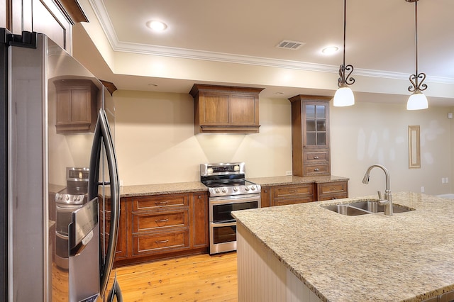 243 Riverbend Dr, Eatonton, GA 31024 - kitchen with stainless steel appliances, light wood-style floors, crown molding, brown cabinets, and light stone countertops