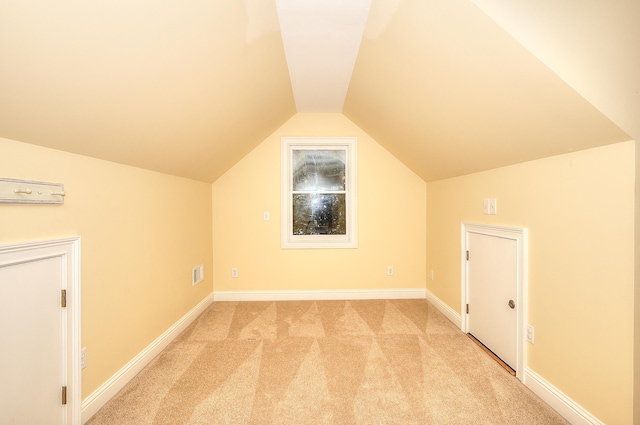 243 Riverbend Dr, Eatonton, GA 31024 - additional living space with lofted ceiling and light carpet