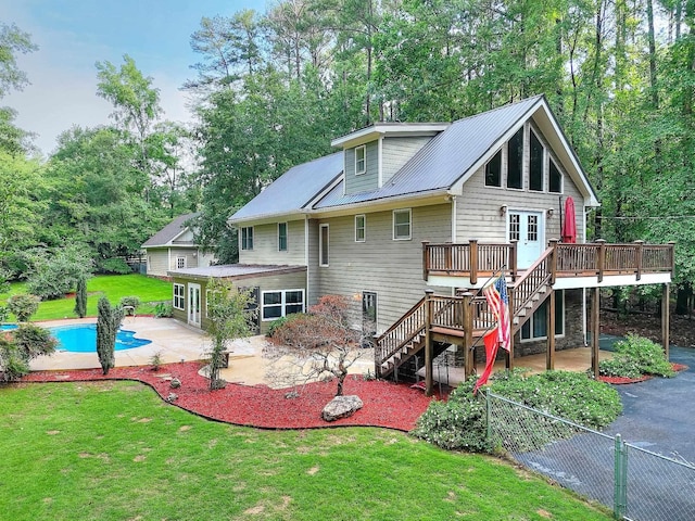 243 Riverbend Dr, Eatonton, GA 31024 - rear view of house featuring a deck, a patio area, stairway, an outdoor pool, and a metal roof