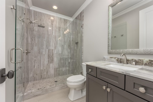 bathroom with crown molding, toilet, vanity, and walk in shower